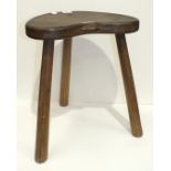 A Robert 'Mouseman' Thompson of Kilburn oak stool with dished kidney-shaped seat, raised on three