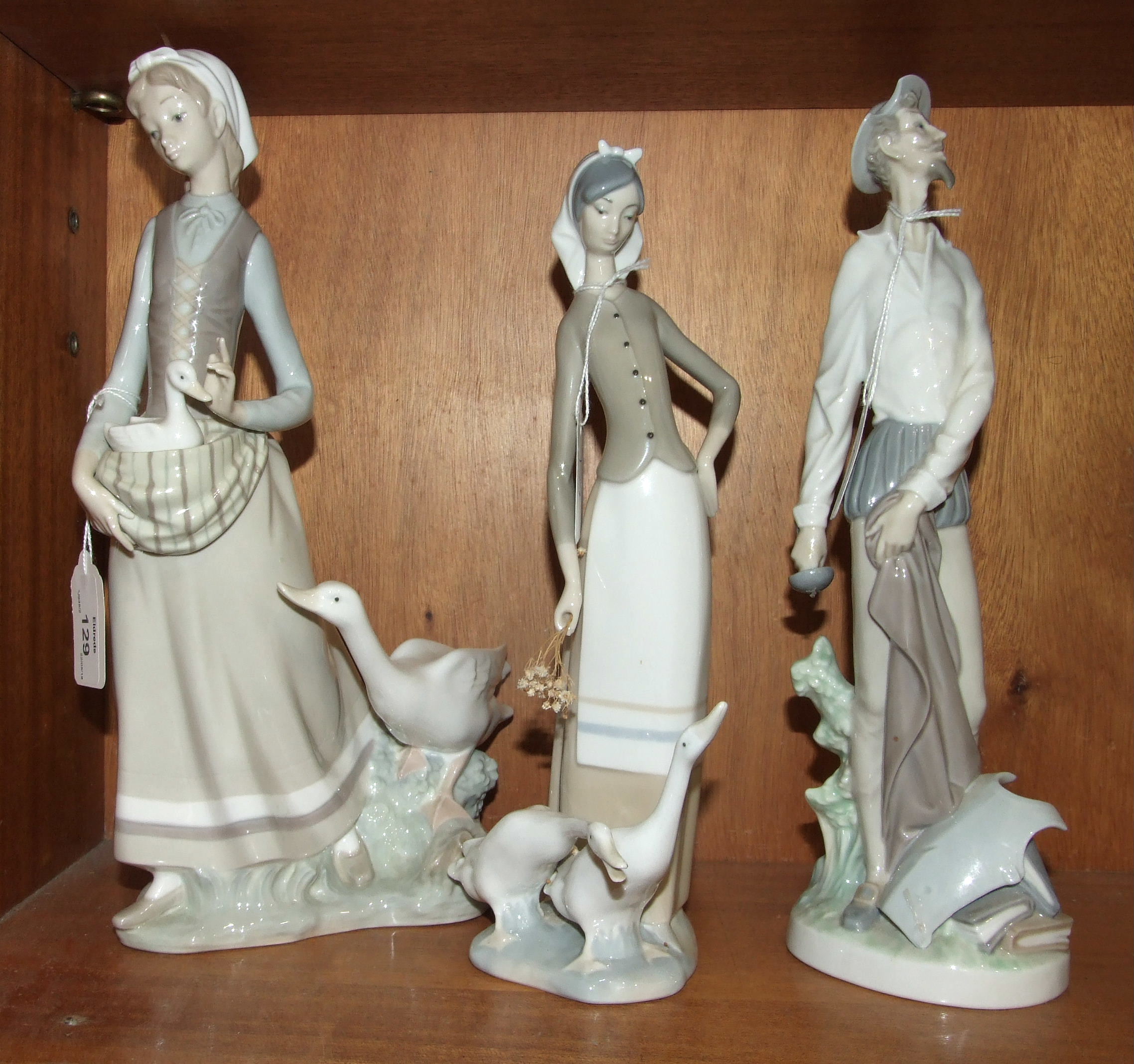 Three Lladro figurines, 'Young girl carrying a duckling within her apron, with larger duck beside