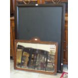 An early-20th century walnut-framed bevelled mirror, 62cm high, 84cm wide and two large