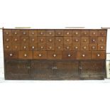 A large mahogany bank of chemist's drawers, comprising forty-three small drawers with glass