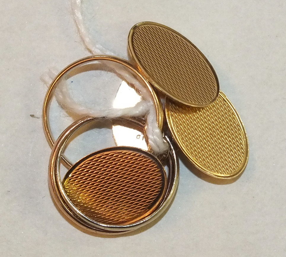 A pair of engine-turned 9ct gold cufflinks, 3.4g and a 9ct gold tri-colour Russian wedding ring,