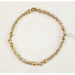 An 18ct gold bracelet of four linked sections of twisted tri-colour gold, 17.8g.