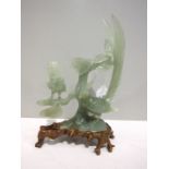 A modern jade figure group of two exotic birds, 20cm high, standing on a carved wood base, stamped