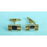 A pair of 9ct gold cufflinks of two rods of yellow gold with a broad white gold panel across, marked