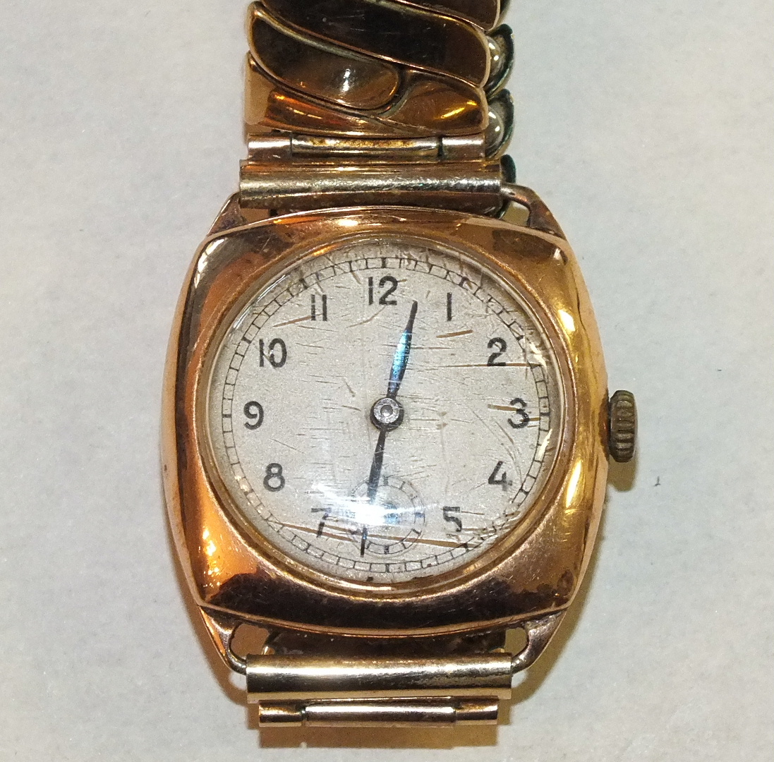 A gentleman's 1940's cushion-shaped 9ct gold wrist watch on plated expanding bracelet, gross