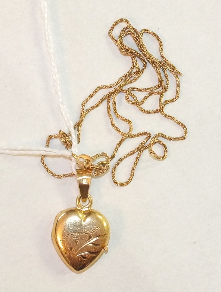 An 18ct gold heart-shaped locket on 18ct gold chain, (a/f), 6.5g.