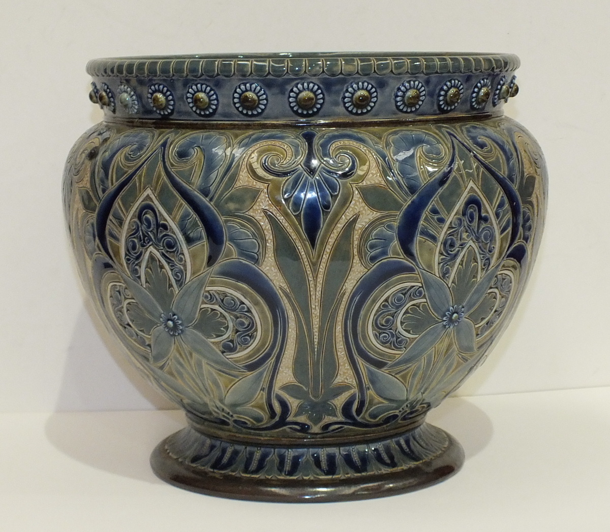 A Doulton Lambeth stoneware jardinière by Edith D Lupton, dated 1881, with overall blue stylised