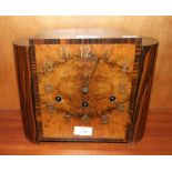 An Art Deco zebrawood chiming mantel clock, the burr wood square dial with raised wooden Arabic