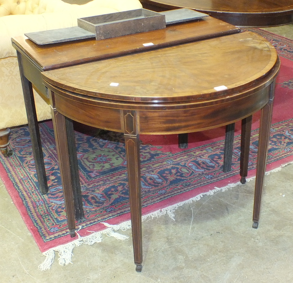 A Georgian mahogany fold-over card table, (in need of restoration), 91cm and another, (2).