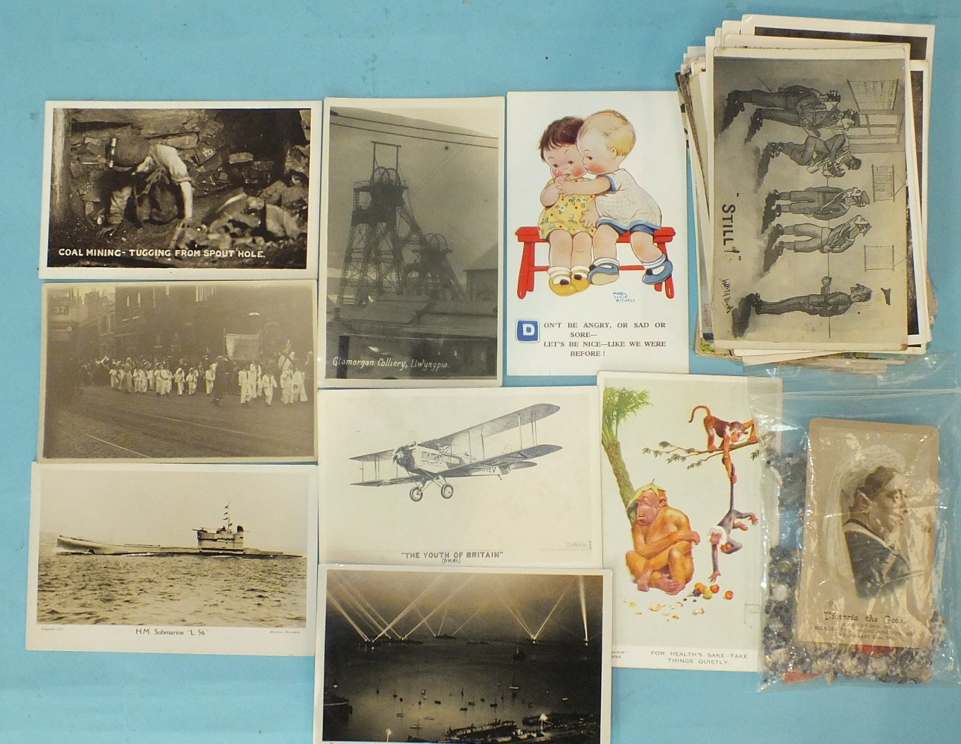 A quantity of loose postcards, including six of coal mining, eleven of ships and submarines, also