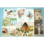 An album of 52 postcards, including a fold-out beetle card, silks, decoupage, hold-to-light,