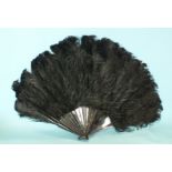 A black ostrich feather fan with tortoiseshell guards and sticks, 40cm (closed).