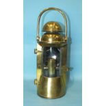 A brass ship's bulkhead lamp by Bulpitt & Sons, Birmingham, with glazed bowed door and removable