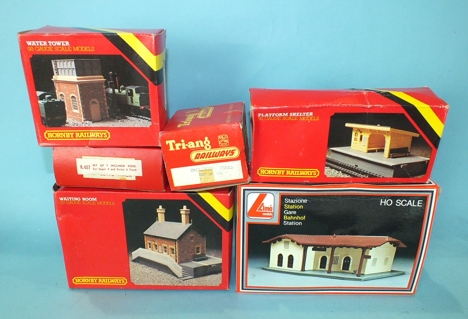 A quantity of OO gauge railway buildings, track and trackside accessories, mainly playworn.