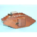 A trench art WWI tank money box of wood and metal construction.