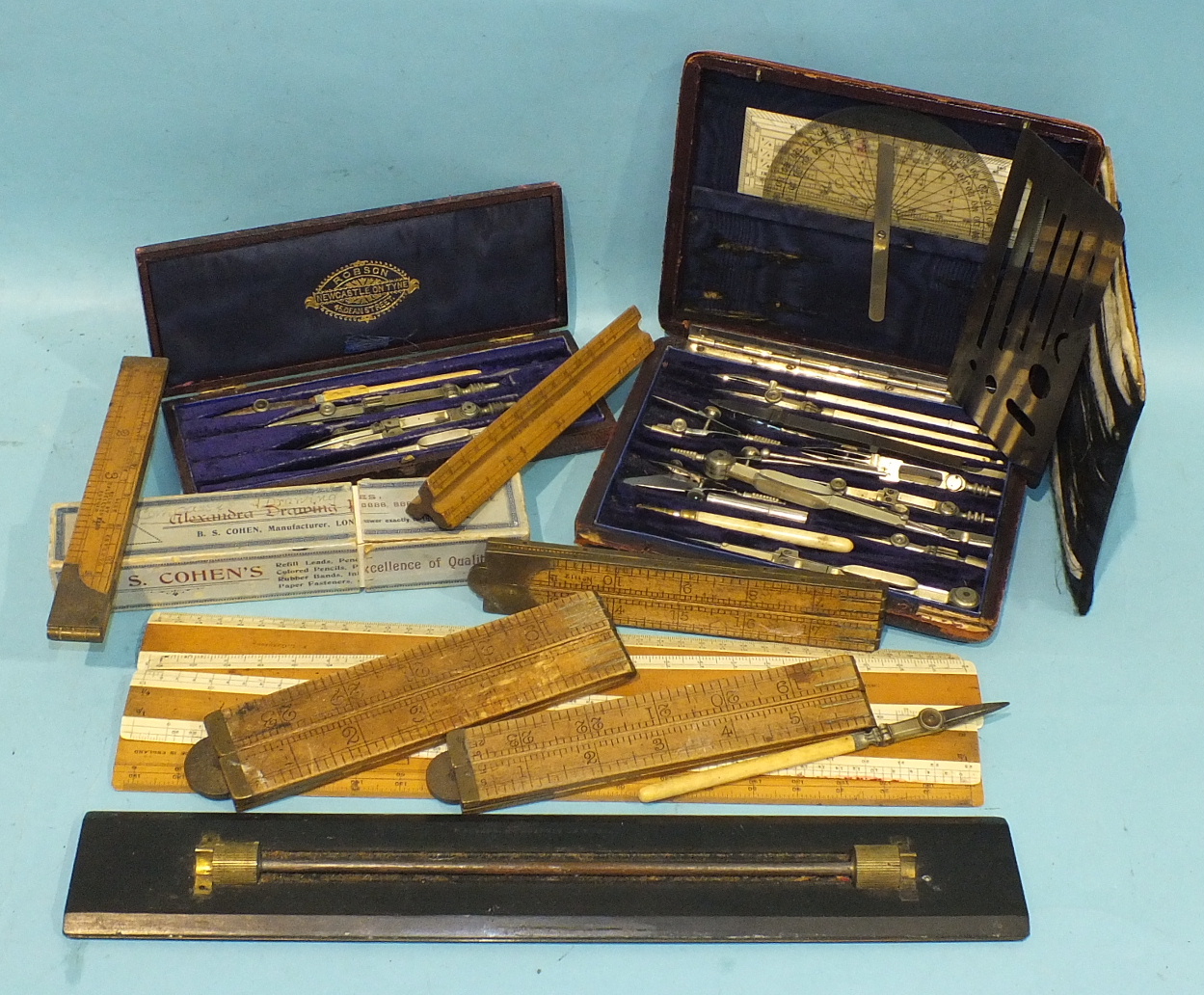 Two part-sets of drawing instruments in leather cases and loose, a 16cm boxwood triangular shape