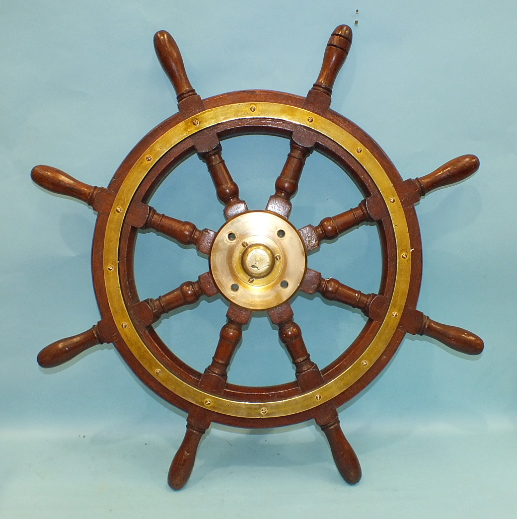 A teak and brass-mounted 8-spoke ship's wheel, 77cm diameter.
