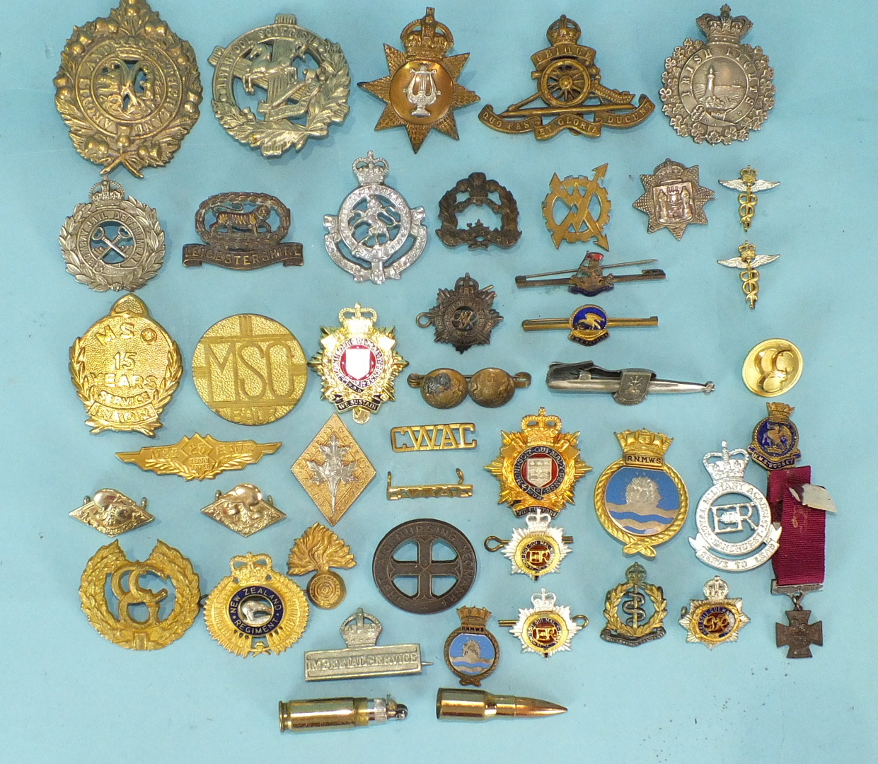 A quantity of cap and other badges, mainly military, to include 'Irish Lights' and 'Bombay Jail