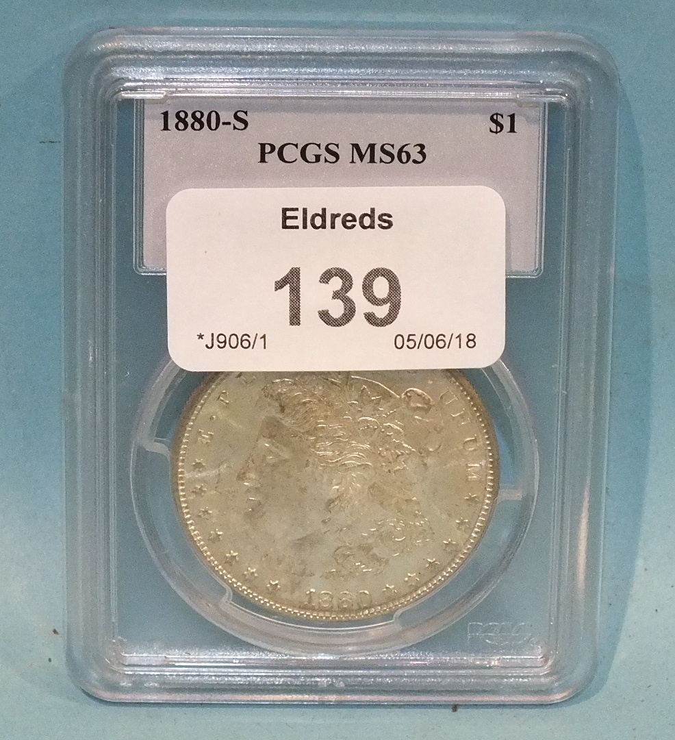 An 1880-S silver 'Morgan Dollar' PCGS M563, in capsule.