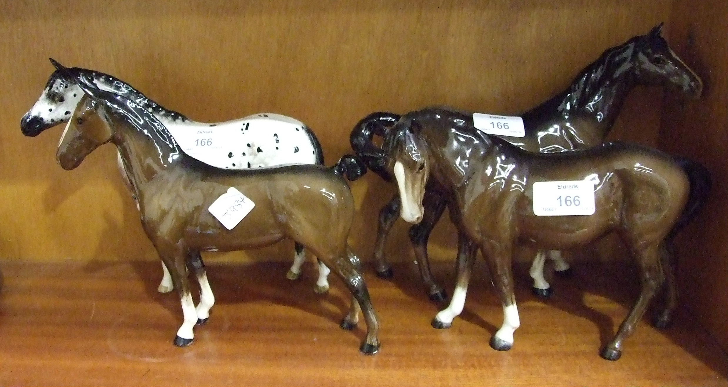 A collection of four Beswick horses, including: 'Appaloosa Stallion', colour way 2, 'Mare (facing