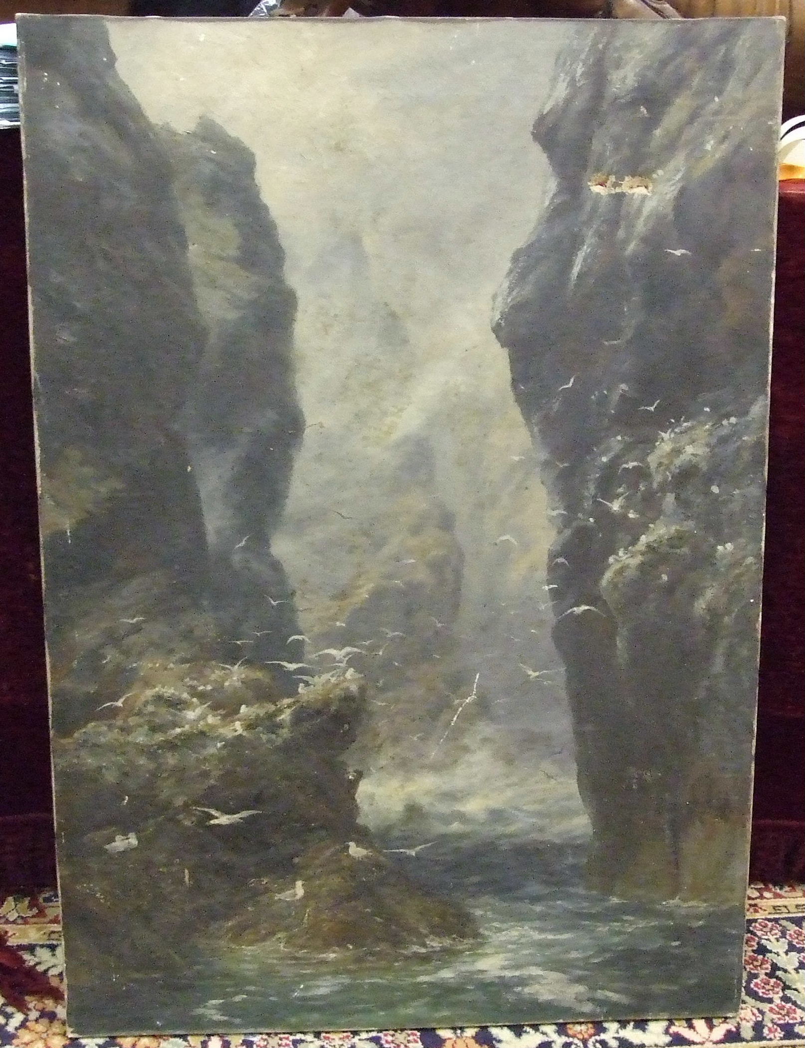 A 19th century oil on canvas painting depicting sea birds resting on a rocky cliff, indistinct