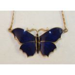 An enamelled gold butterfly pendant, (a/f), on unmarked yellow metal chain, gross weight 12g.