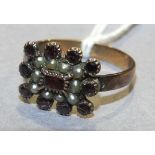 An early-19th century garnet and pearl cluster mourning ring.