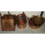 An oak coal box with brass hinges and handle, two copper coal helmets and other metal ware.