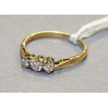 A three-stone diamond ring in 18ct yellow gold and platinum mount, size J, 1.6g.