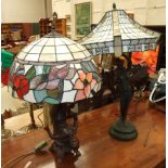 Two Tiffany-style table lamps with leaded glass shades and figural bases, (2).