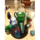 A collection of coloured and clear glassware, including decanters, jugs, vases, etc.