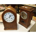 A mahogany mantel clock of arch form with gong-striking movement, 36cm high and an oak-cased