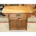 A 20th century Chinese hardwood side cabinet having a single drawer and two cupboard doors, 73cm