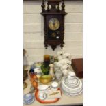 A stained wood case wall clock, two pairs of Staffordshire dog ornaments, a modern globe on copper