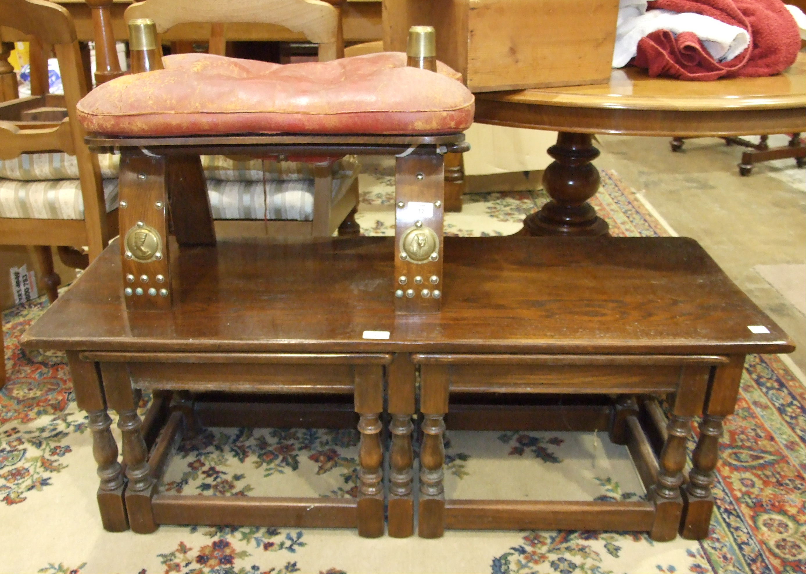 A nest of three oak tables and a camel stool with leather seat, (2).