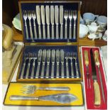 A set of twelve each plated fish knives and forks in oak case, a pair of plated fish servers and