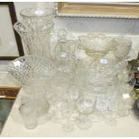 A collection of cut glassware, including vases, bowls, drinking glasses, etc.