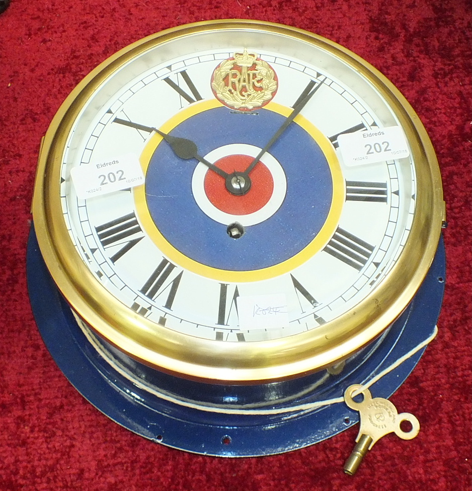 A brass bulkhead clock, now painted blue, the dial with Roman numerals and applied RAF roundel to