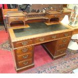 A Late-Victorian walnut knee-hole writing desk, the galleried top with two small drawers and writing
