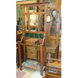 An Edwardian stained mahogany hall stand with central square mirror above tiled back, glove box