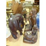 An Oriental carved wood figure group depicting a male seated, a young boy and a dog, 42cm high, 47cm