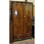 A Georgian style mahogany bow-fronted two-door wardrobe with dentil cornice and base drawer, 116cm
