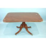 A mahogany and rosewood-banded rectangular breakfast table, the tilt-top on turned column and reeded