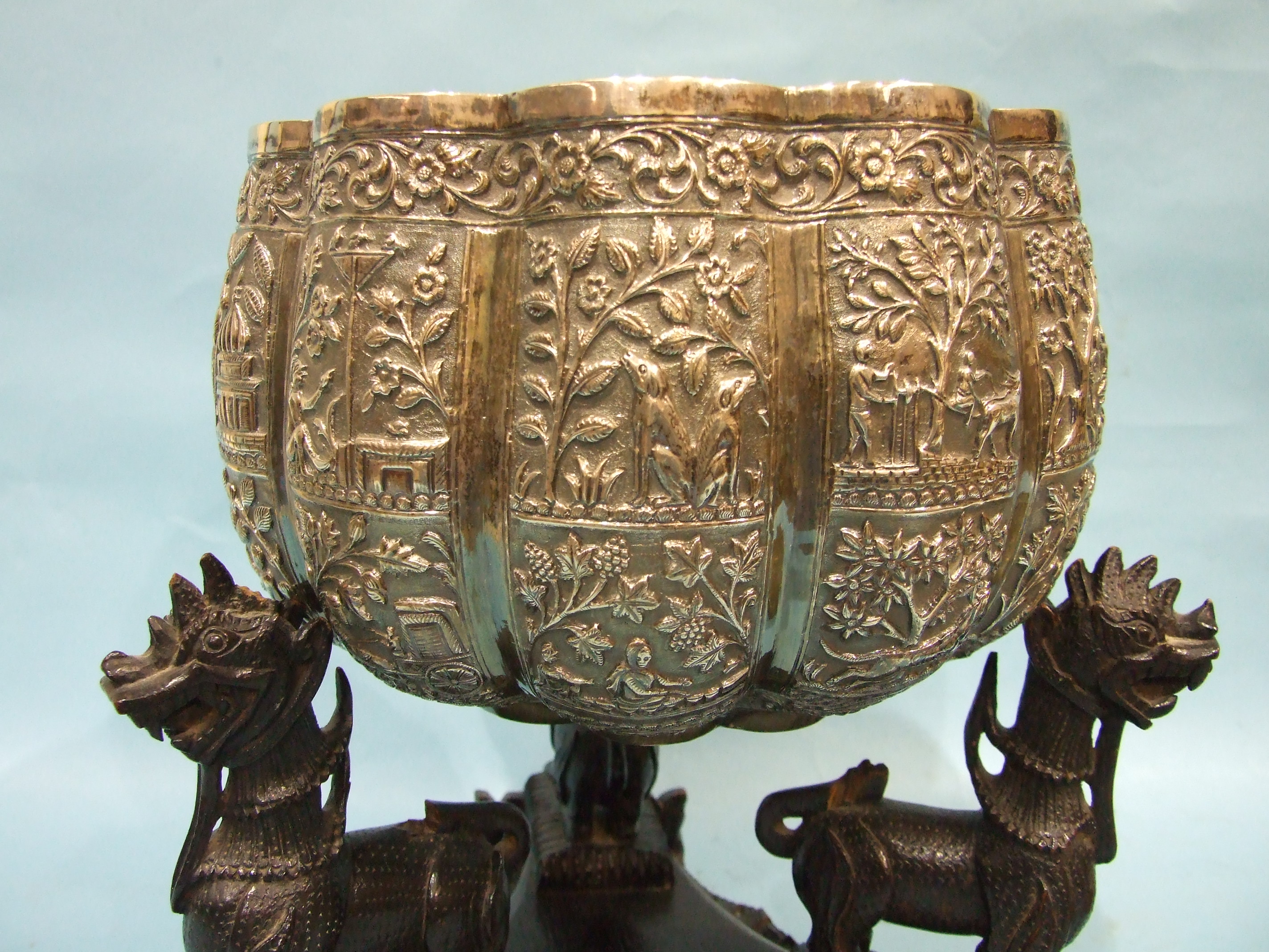 A large late 19th century Burmese white metal bowl of lobed form embossed with panels of figures, - Image 2 of 3