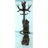 A late-19th/early-20th century Black Forest carved wood hall stand in the form of a large carved