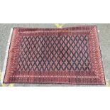A Baluchi rug with overall lozenge design on indigo ground, 155 x 246cm.