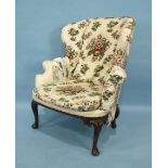 A mahogany wing armchair in the mid-18th century style, with generous seat and carved cabriole front