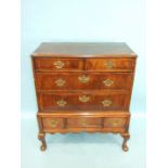 An 18th century walnut chest of two short and two long feather-banded drawers, on associated base