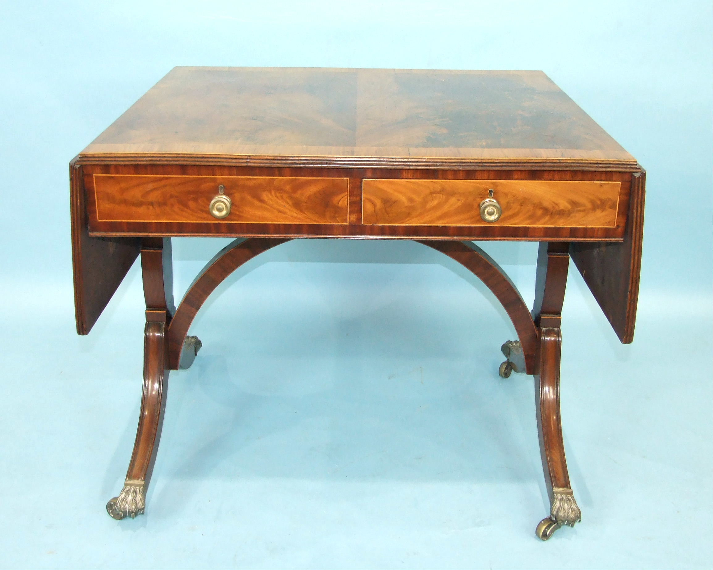 An early-19th century mahogany sofa table, the cross-banded top with two drop leaves above two