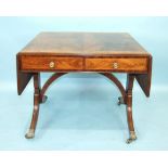 An early-19th century mahogany sofa table, the cross-banded top with two drop leaves above two